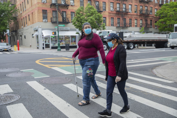 Janet Mendez (left) who spent almost three weeks in hospital with COVID-19, walks with her mother Maria in New York.