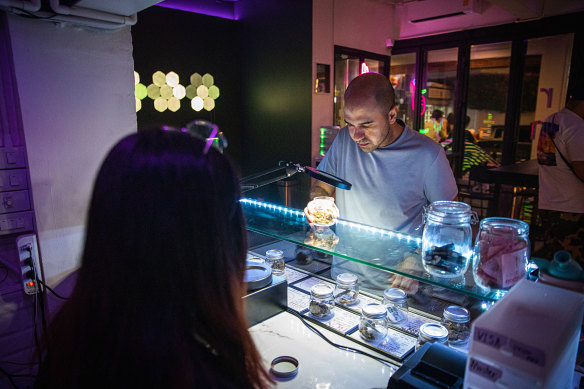 A customer selects marijuana for purchase at a dispensary in the Asoke neighborhood of Bangkok.