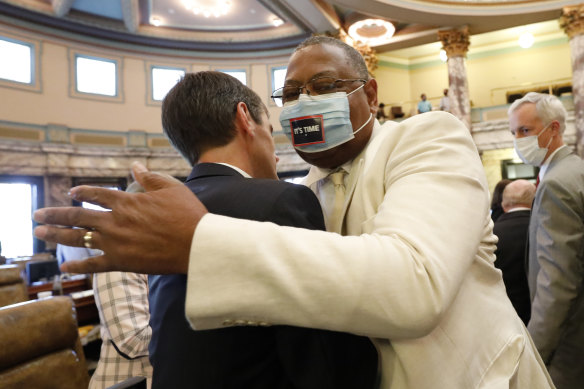 Senator Briggs Hopson is hugged by Senator Robert Jackson after the Senate voted to change the state flag. 