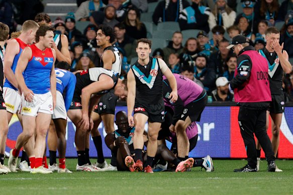 Aliir Aliir was helped to his feet after an ugly incident.