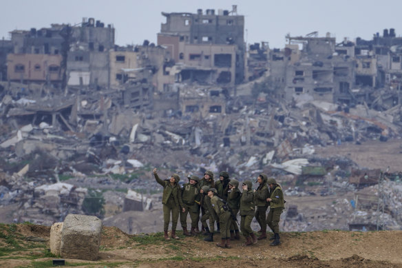 Israeli female soldiers pose for a photo on a position on the Gaza Strip border, in southern Israel.