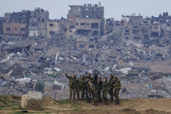 Israeli female soldiers pose for a photo on a position on the Gaza Strip border, in southern Israel, on Monday.