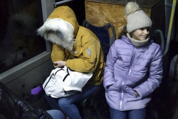 Two women sit inside a bus waiting to be evacuated to Russia from Donetsk.