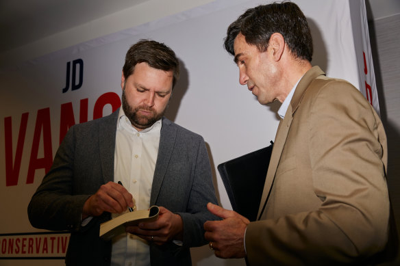 Then senate candidate J.D. Vance signs a copy of his memoir “Hillbilly Elegy” during a campaign event in Portsmouth, Ohio in 2022.