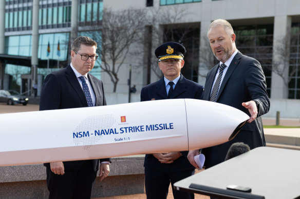 Minister for Defence Industry and Capability Pat Conroy, Air Marshal Leon Phillips and general manager of Kongsberg Defence Australia John Fry with a model of the naval strike missile in Canberra on Thursday.