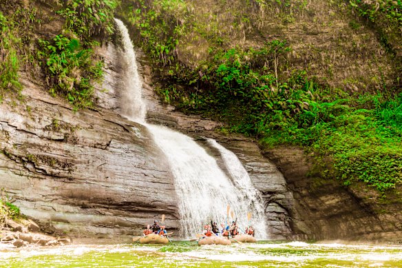 Group rafting through Navua river canyon, Fiji.