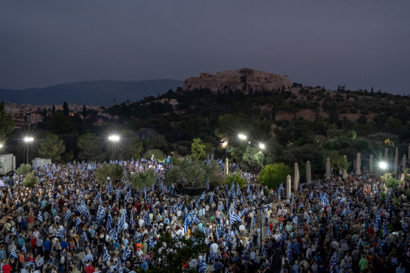 The Acropolis is seen in the distance during a pre-election rally for Kyriakos Mitsotakis. 