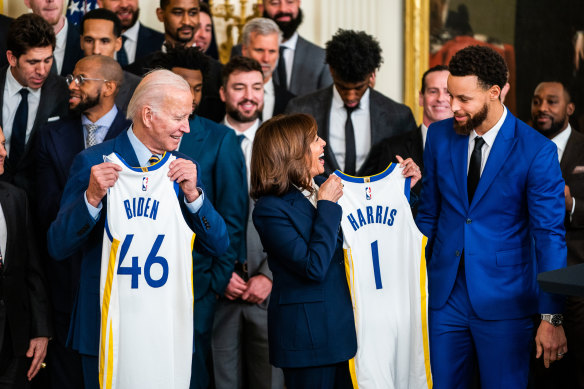 Golden State star Stephen Curry presents Vice President Kamala Harris and President Joe Biden with Warriors jerseys at the White House last year.