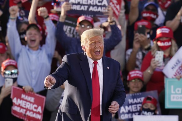 On the way back? Donald Trump works the crowd at a campaign rally in Tucson, Arizona.