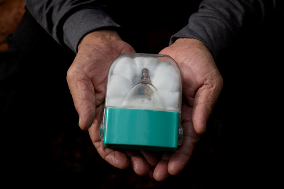 One of the few belongings he brought with him was a Virgin Mary statue that he says helped keep him safe in hiding for years.