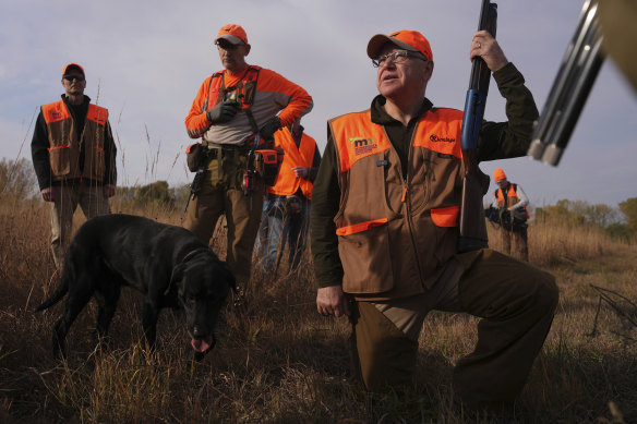 Tim Walz stops during a break to give water to the hunting dogs during the annual Minnesota Governor’s Pheasant Hunting Opener.
