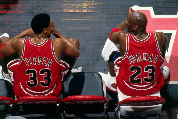 Scottie Pippen and Michael Jordan of the Chicago Bulls sit on the bench during a game in January 1998.