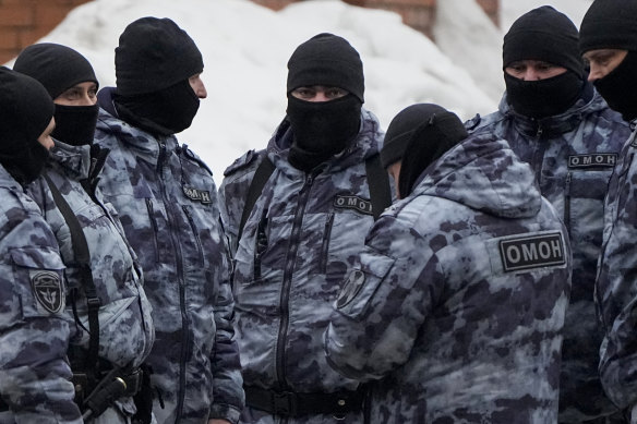 Riot police near the church on Friday.