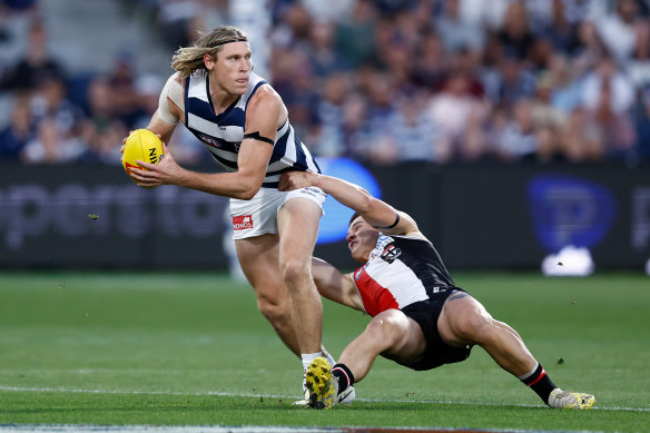 Mark Blicavs is tackled by Liam Stocker.