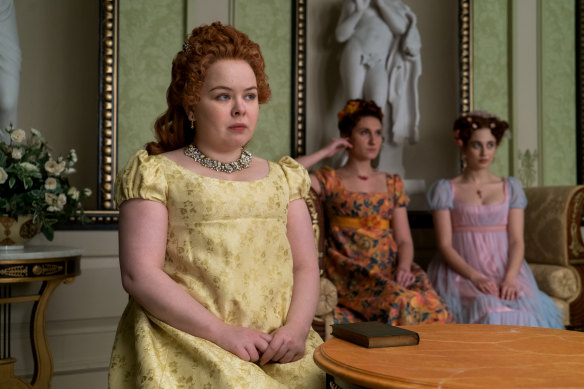 Nicola Coughlan as Penelope Featherington in Bridgerton, with co-stars Bessie Carter as Prudence Featherington and Harriet Cains as Phillipa Featherington.