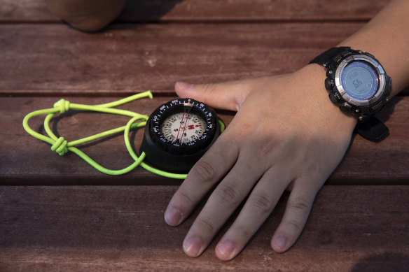 Kwon Pyong, an asylum seeker from China, shows the compass he used to navigate to South Korea.