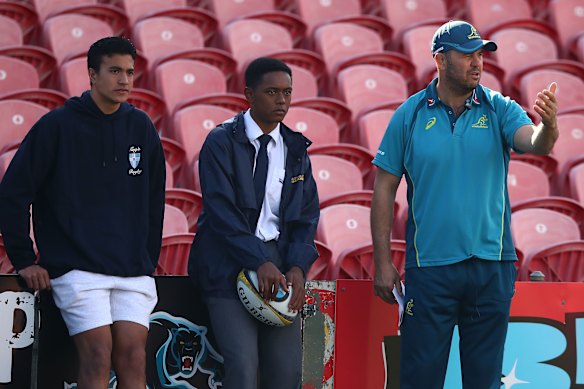 Michael Cheika and a 14-year-old Joseph Suaalii at a Wallabies training session.