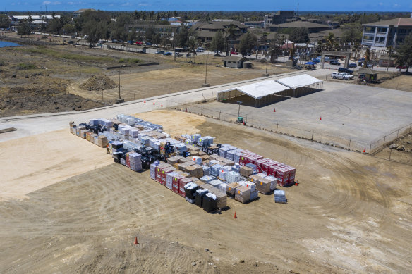 In this photo provided by the Australian Defence Force, aid supplies are stacked at the port at Nuku’alofa, Tonga. 