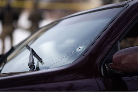 A large bullet hole in the windscreen of a vehicle at the scene of the shooting in Minneapolis.