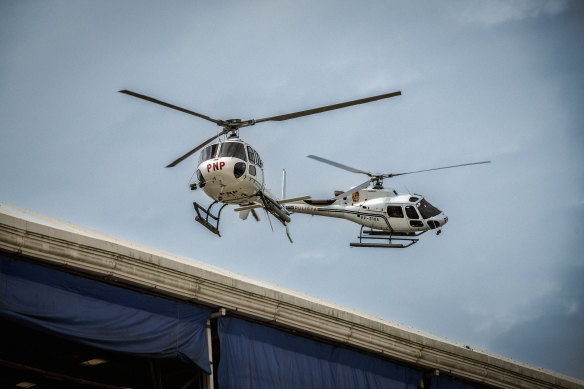 Police helicopters fly over the Kingdom of Jesus Christ compound.