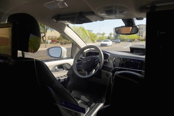 The empty driver’s seat on board a Waymo vehicle.