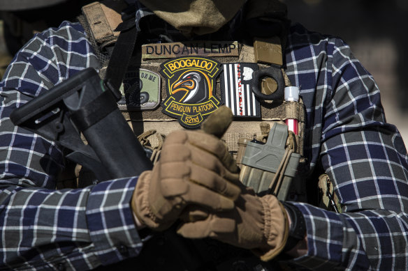 An armed protester wearing a “Boogaloo” patch attends a demonstration outside the Texas State Capitol in Austin, Texas last year. 