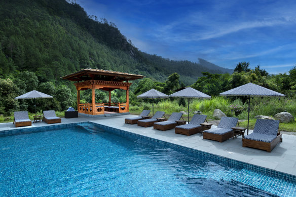 A lush, dramatic backdrop at the outdoor heated pool.