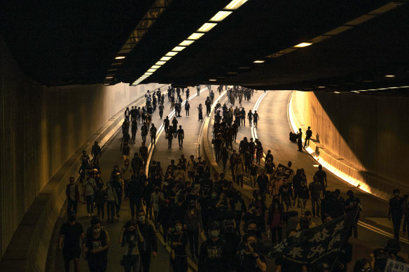 Demonstrators crowd a road during a protest in the Tsim Sha Tsui area of Kowloon, Hong Kong, on December 1. 