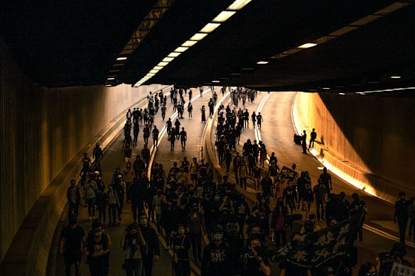 Demonstrators crowd a road during a protest in the Tsim Sha Tsui area of Kowloon, Hong Kong, on December 1. 