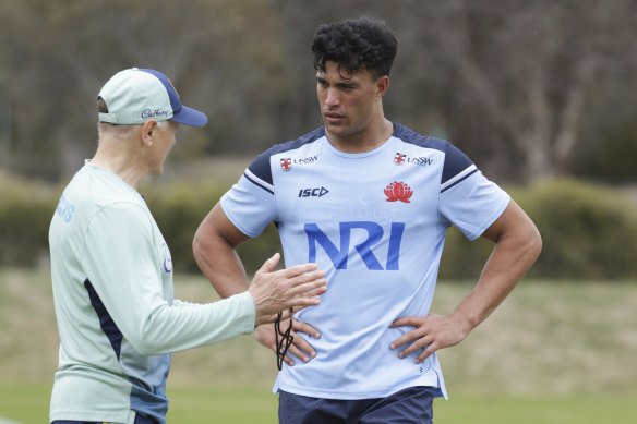 Joseph Suaalii chatting to coach Joe Schmidt in camp with the Wallabies.