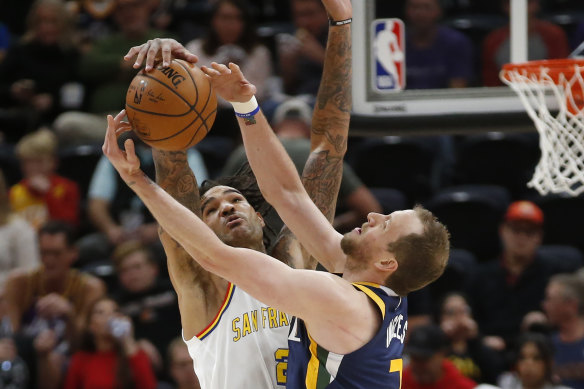 Golden State Warriors centre Willie Cauley-Stein, left, and Utah Jazz forward Joe Ingles, right, battle for the ball. 