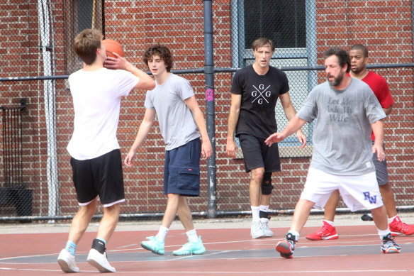 Adam Sandler (far right) and Timothee Chalamet (second from left) enjoying a pickup game in NYC last month.
