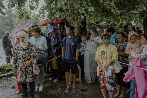 People who evacuated from the border regions, including from Sudzha, wait for distribution of aid from House of Good Deeds, a local organization, in Kursk.