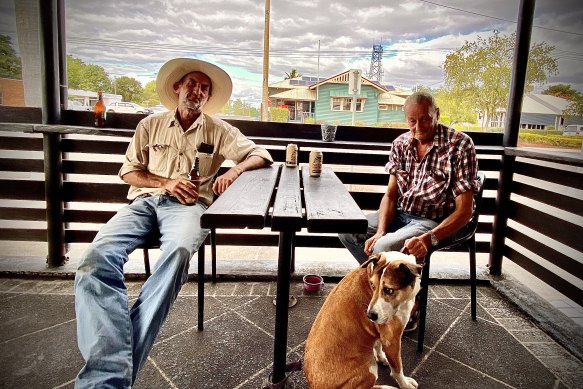 John Cunningham (left) with John “Crowbar” Hughan and dog Mishka at Clermont’s Grand Hotel on the (unremarked) anniversary of Bob Brown’s convoy rolling into town.