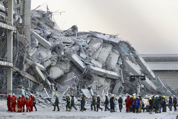 Rescuers work at the site a high-rise building under construction that collapsed after a 7.7 magnitude earthquake in Bangkok on Friday.