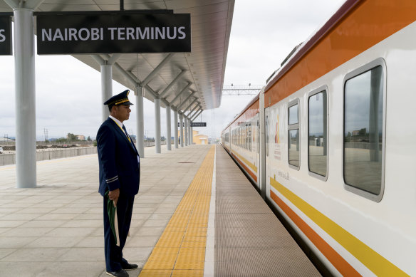 A Kenya Railways employee sends off the train from Nairobi to Mombasa on the sleek new railway, built by China. 