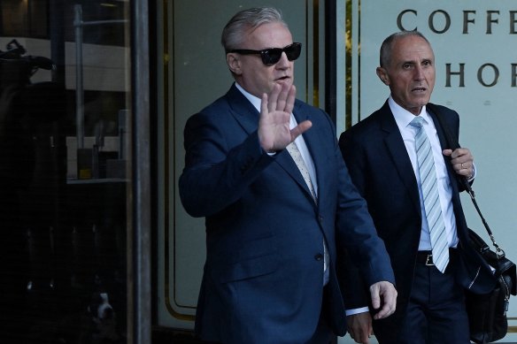 Paul Kent leaves the Downing Centre in sunglasses on Tuesday alongside his lawyer, George Elias.