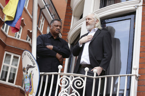 Julian Assange stands on the balcony of the Embassy of Ecuador with Reverend Jesse Jackson. The embassy staff found him a difficult housemate.