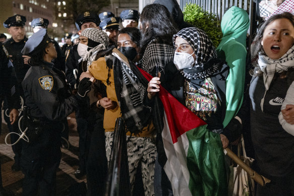 Protesters hold their ground near a main gate at Columbia University before arrests started.