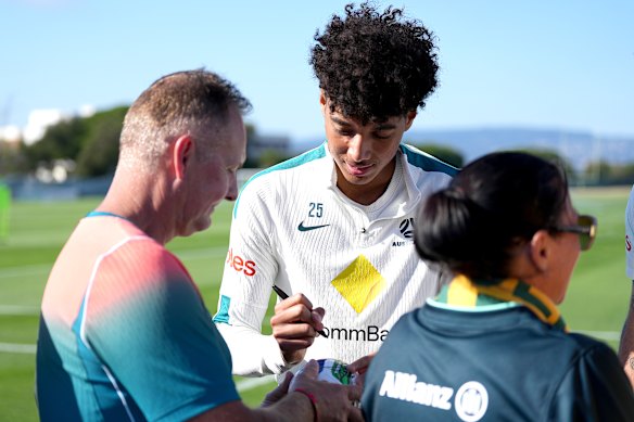 Lucas Herrington signs an autograph at a training session.