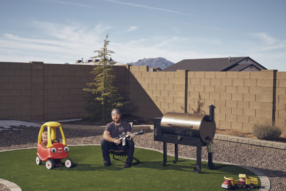 Keith, his Traeger wood-fired smoker and his AR15 semi-automatic rifle. 