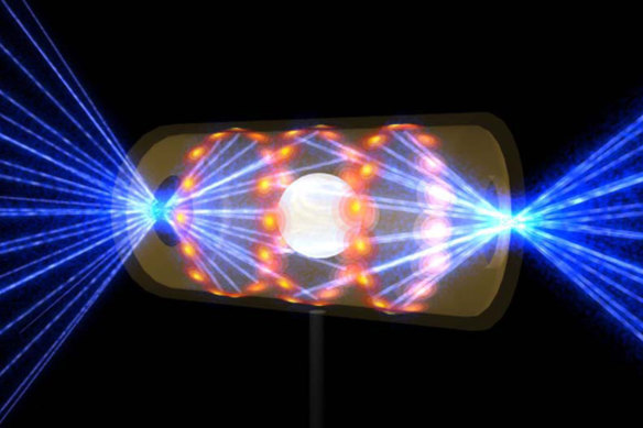 A target pellet inside a hohlraum capsule with laser beams entering through openings on either end. The beams compress and heat the target to the necessary conditions for nuclear fusion to occur.
