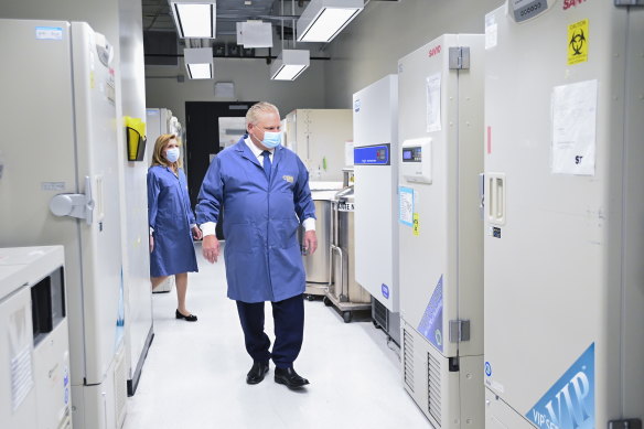 Ontario Premier Doug Ford, front, and Ontario Health Minister Christine Elliott inspect freezers ahead of COVID-19 vaccine distribution in Toronto.