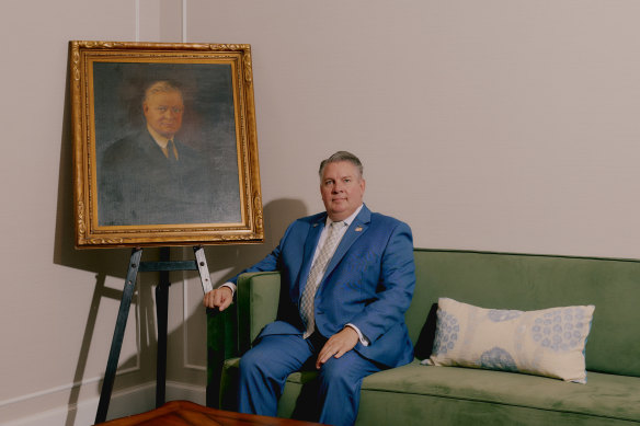 Bill Villanova, funeral director, with a painting of the namesake of the Frank E. Campbell mortuary.