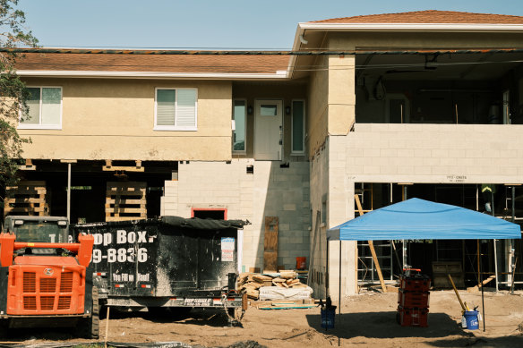 A home in Shore Acres in the process of being raised onto concrete pillars.