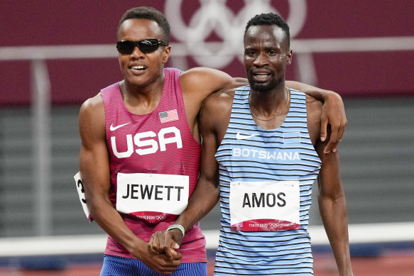 Isaiah Jewett, of the United States, and Nijel Amos, right, of Botswana, walk off after falling in the men’s 800-meter semi-final.
