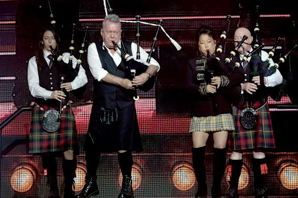 Jimmy and Jane Barnes on stage with bag pipes.