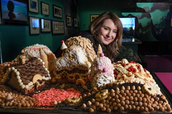 The Magic of Animation curator Kristen McCormick with the cake-and-cookie village made as a reference model for the animators of Wreck-It Ralph.