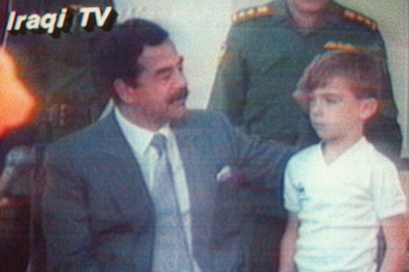 August 1990: Five-year-old hostage  Stuart Lockwood appears with Saddam Hussein on Iraqi TV days after the invasion of Kuwait.