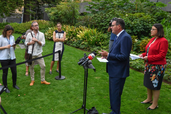 Reporters are kept at a safe distance from Premier Daniel Andrews and Health Minister Jenny Mikakos on Thursday morning.